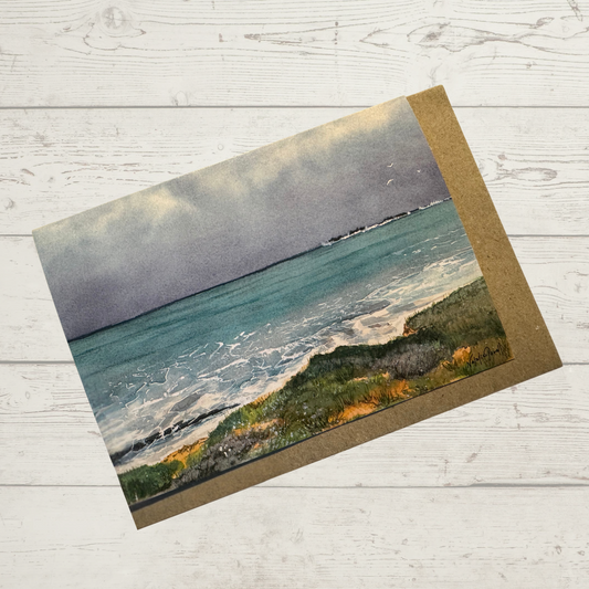 Image of actual card with natural coloured kraft paper envelope. Image depicts dark storm clouds crossing the turquoise ocean at Burns Beach, Perth Western Australia.
