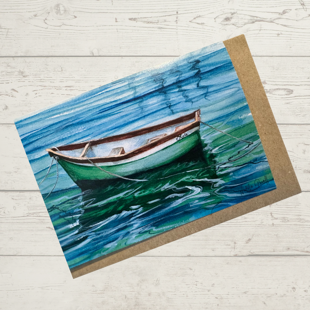 Image of actual card with natural coloured kraft paper envelope. Image depicts a tranquil scene of a moored rowboat named 'Kate' on calm water.